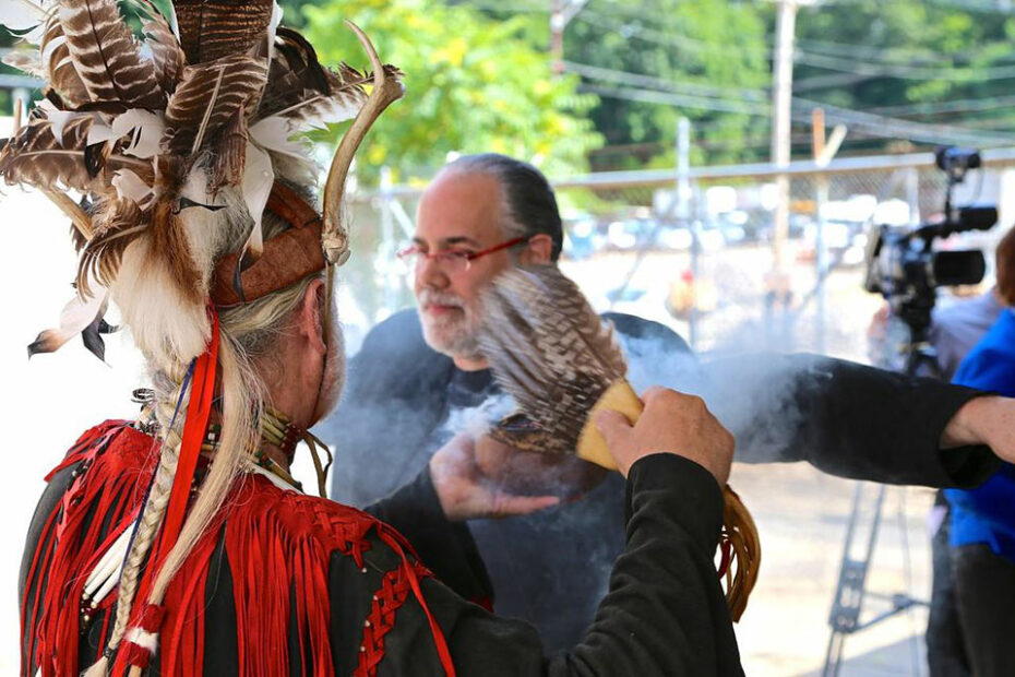 Barnaby Evans being smudged by Roger Desrosiers of the Poconocutt Nation.