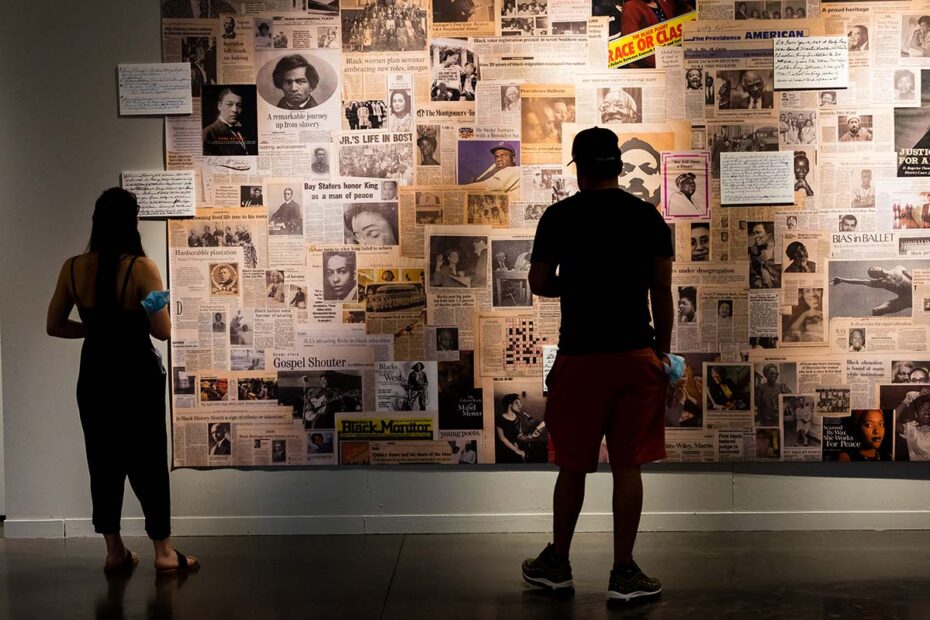 Two visitors look at artwork in the “ANNYE RAYE PITTS: WITNESS” installation at the WaterFire Arts Center. Photograph by Matthew TW Huang.