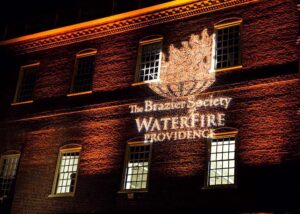 The Brazier Society logo projected on a wall.
