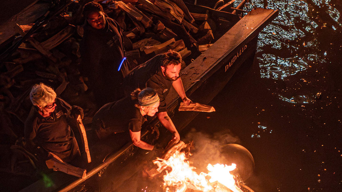 Fire-tenders add wood to a brazier at WaterFire. Photograph by Tom Backman.