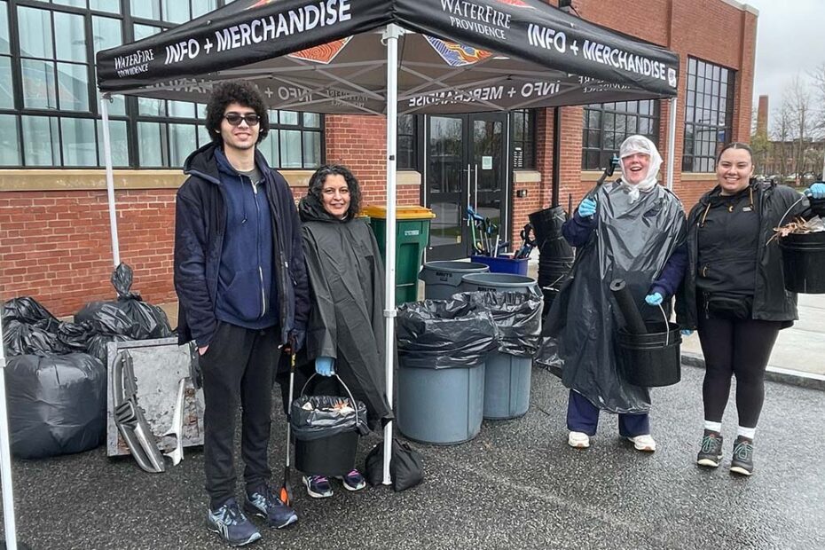 Volunteers, interns, and staff staying dry at our Earth Month Cleanup at the WaterFire Arts Center. Photograph by Laura Duclos.